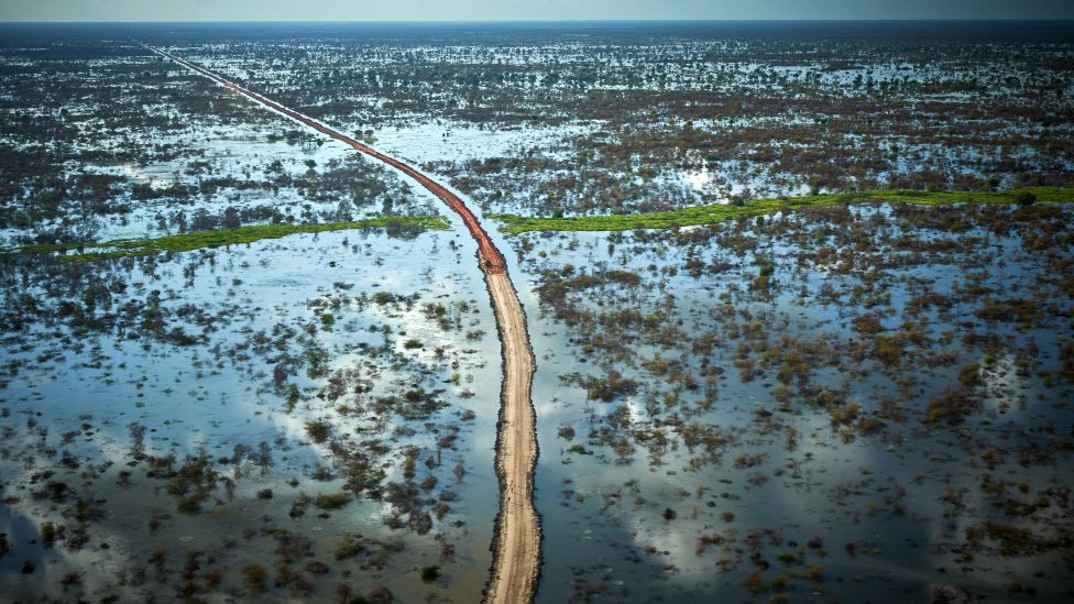 An aerial view of a raised road amid a flooded landscape near Bentiu in South Sudan