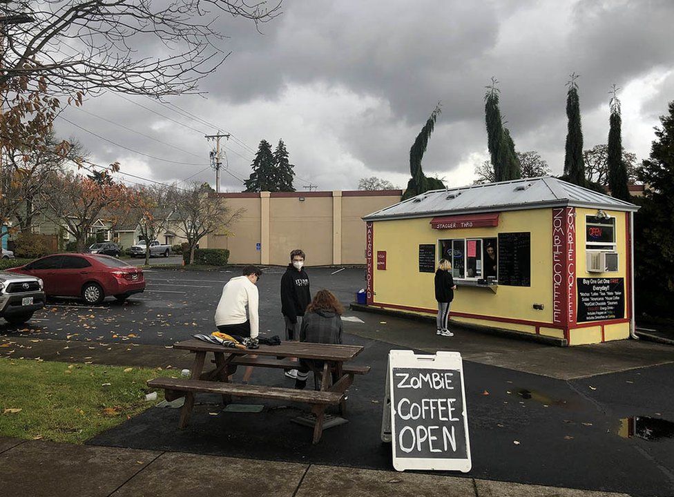 People wearing masks outside a small cafe in Gladstone, Oregon