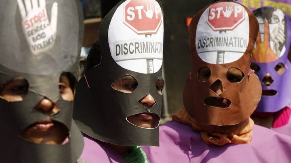 Garment workers wear masks during a rally in Dhaka, Bangladesh