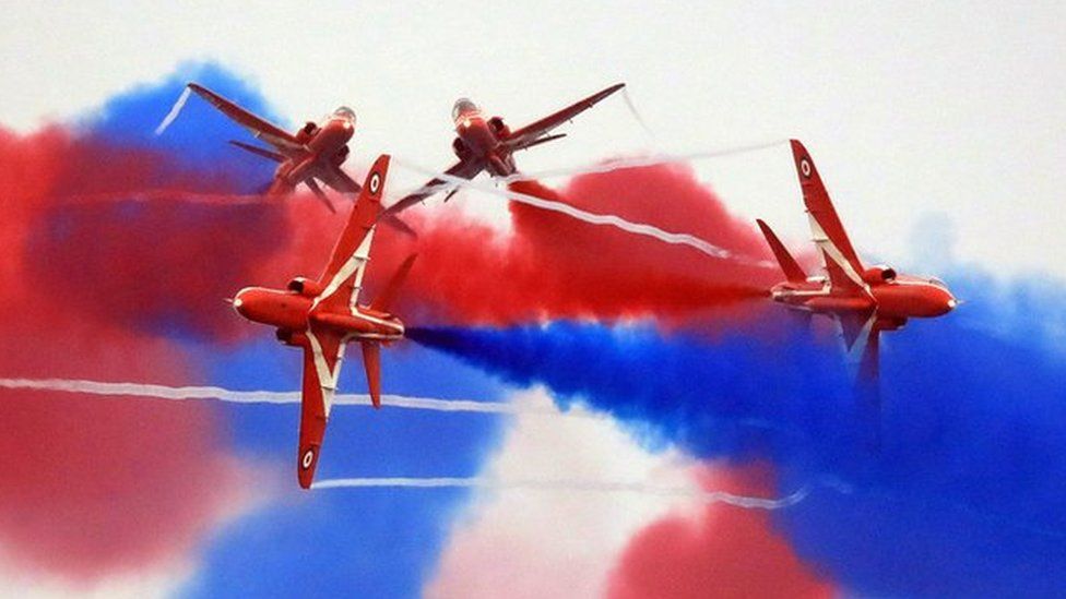 Red Arrows performing at the Sunderland International Airshow with coloured smoke in the sky