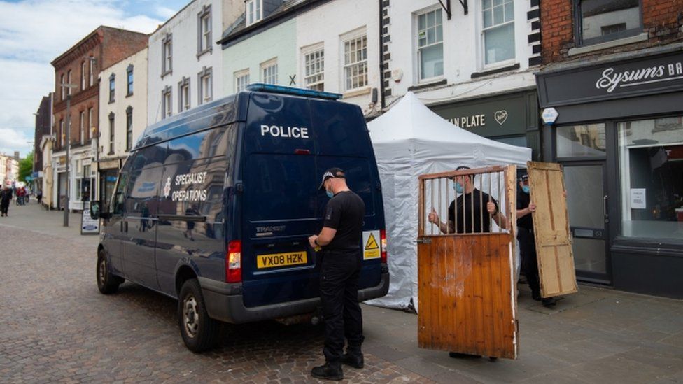 Police removing items from the Clean Plate Cafe in Gloucester