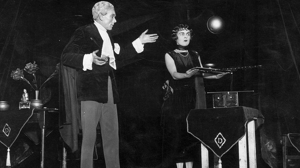 Magician Mr Devine on stage with his assistant at the Wembley Exhibition