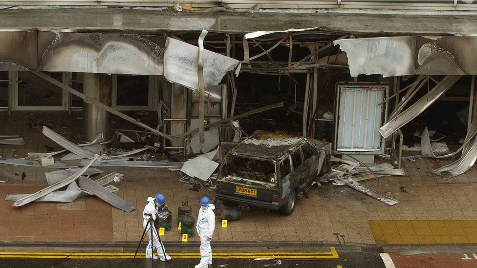 Police go over the scene at Glasgow Airport after a blazing car was driven into the airport's main terminal July 1, 2007 in Glasgow, Scotland. S