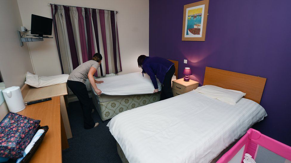 Welcome centre workers prepare beds for Syrian refugees at an undisclosed location on December 14, 2015 in Belfast