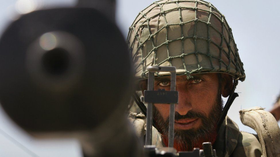 A Pakistani army soldier mans a heavy machine gun at a military outpost near Wana April 11, 2007 in Pakistan's South Waziristan tribal area near the Afghan border. T