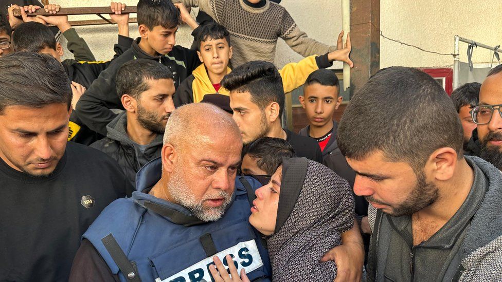 Wael al-Dahdouh pictured with mourners at the funeral of his son