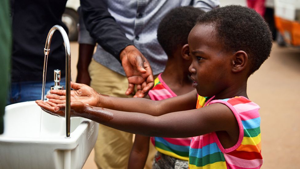 A girls washing her hands at a public sink in Kigali, Rwanda - Wednesday 11 March 2020