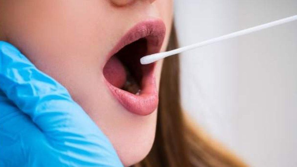 Woman receiving mouth swab