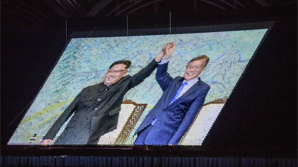 An image of North Korea"s leader Kim Jong Un and South Korea"s President Moon Jae-in is projected during a "Mass Games" artistic and gymnastic display