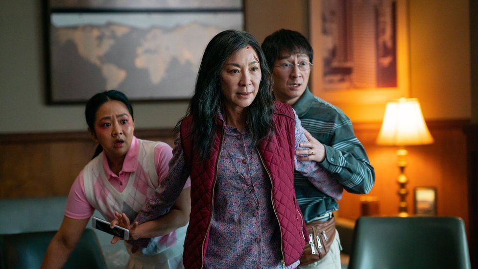 Michelle Yeoh as Evelyn Wang, Stephanie Hsu as Joy Wang, and Ke Huy Quan as Waymond Wang in the film Everything Everywhere All at Once