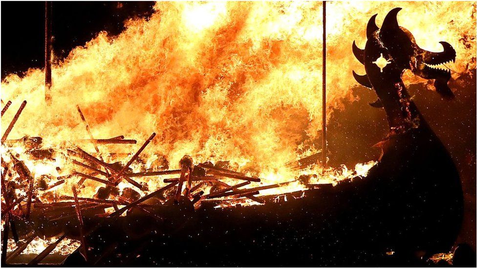 A burning boat with a dragon's head