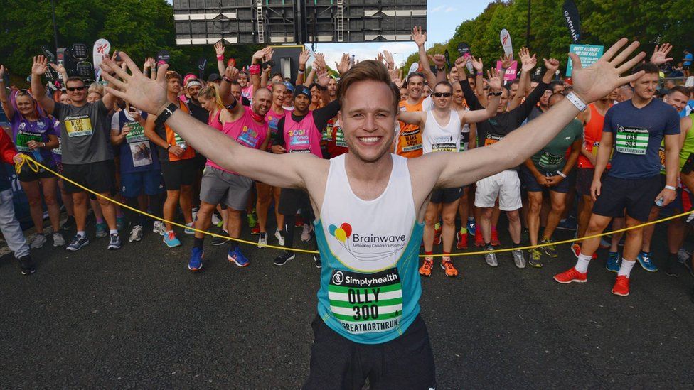 Pop singer Olly Murs at the start line as runners gather behind him