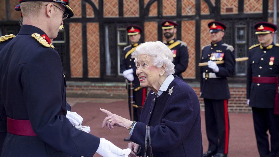 Britain's Queen Elizabeth II (R) gestures as she presents The Captain General's Sword to representatives of the Royal Regiment of Canadian Artillery to mark the 150th Anniversary of the foundation of A and B Batteries, on the Parade Ground of Windsor Castle
