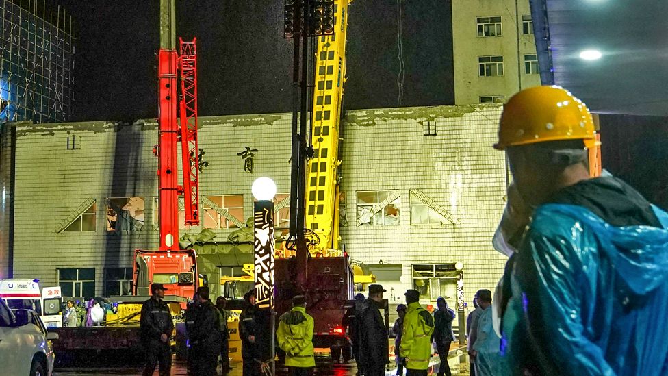 Rescuers work at a school gym after the roof of the building collapsed in Qiqihar, in China's north-eastern Heilongjiang province early on July 24, 2023