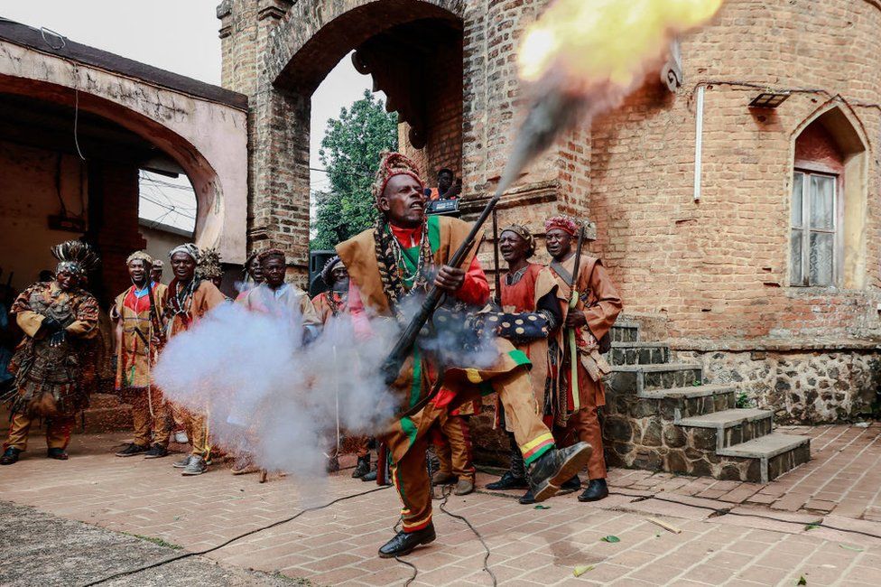 A Bamoun warrior responsible of the security of the Sultan King of the Bamouns shoots into the air during the start of the inauguration ceremony of the new Bamoun Kings Museum in Foumban.