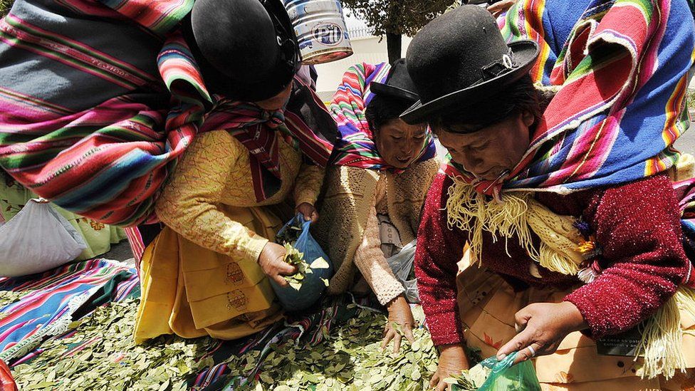 Aymara women chew coca leaves in front of the US embassy to Bolivia in January 2011.