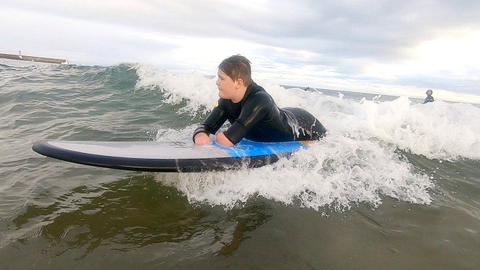 Jade Edward surfing