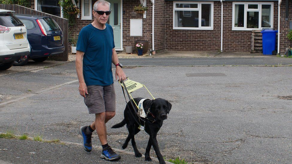 Jon Petty with his guide dog