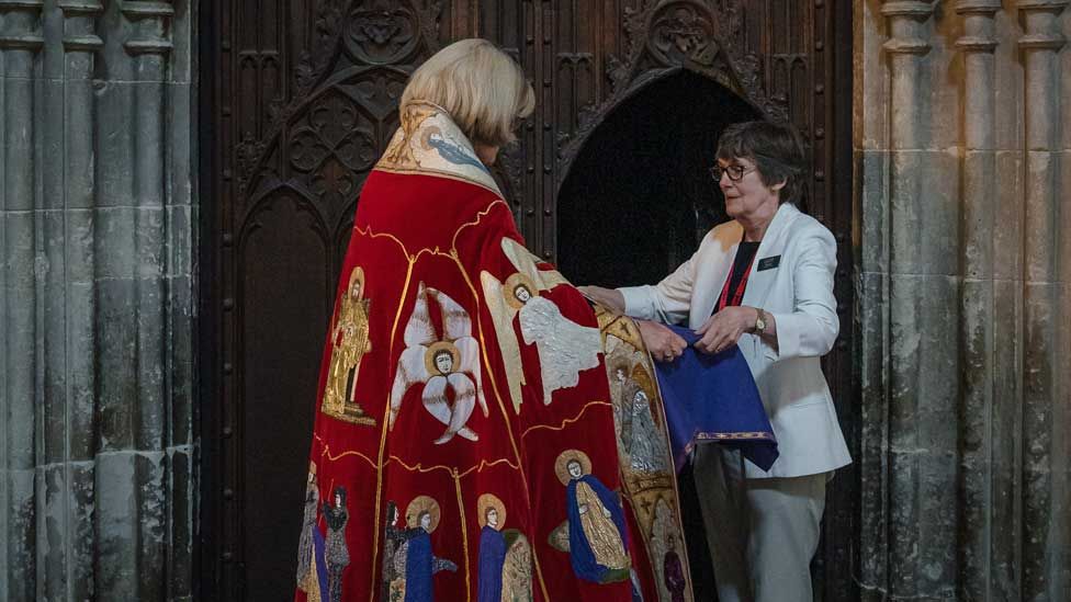 Julia Low hands the Dean the Abbot's ossuary
