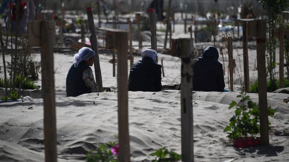 Uighur women praying in a graveyard on the outskirts of Hotan in China's northwest Xinjiang region