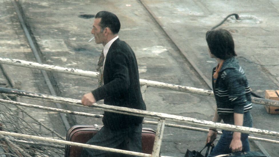 People boarding a boat for the UK