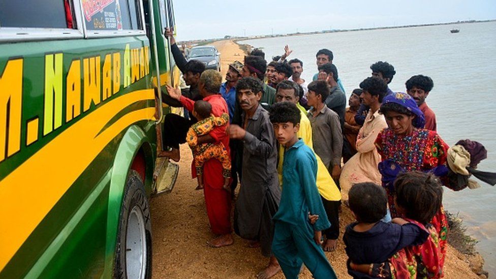 Residents evacuate from a coastal area of Keti Bandar before the due onset of cyclone Biparjoy, in Thatta district of Pakistan's Sindh province on June 13, 2023.