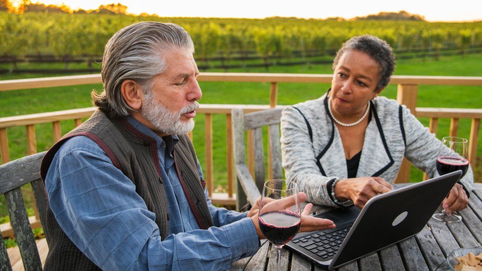 Couple on computer in rural setting