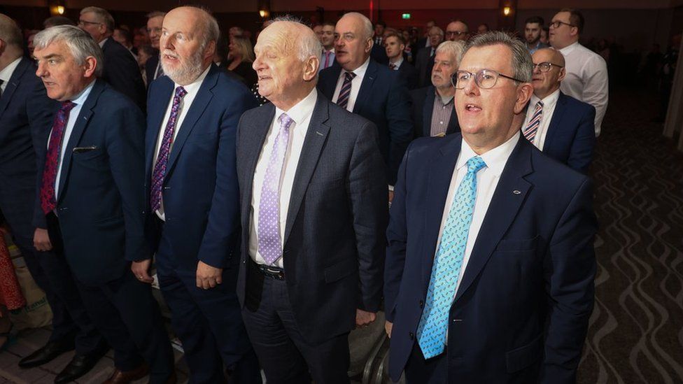 DUP leader Sir Jeffrey Donaldson (front right) with party colleagues sing the national anthem closing the party's annual conference at the Crowne Plaza Hotel in Belfast