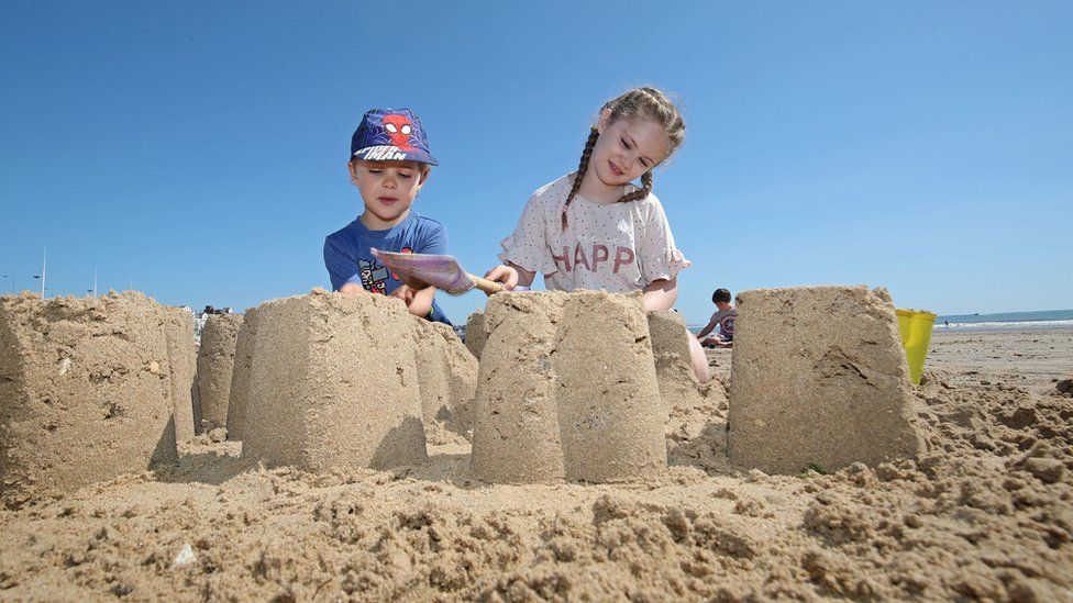 Zachary Bower, 4, and Isabelle Bower, 8, make sand castles in Bridlington, East Yorkshire, as Thursday could be the UK"s hottest day of the year with scorching temperatures forecast to rise even further.