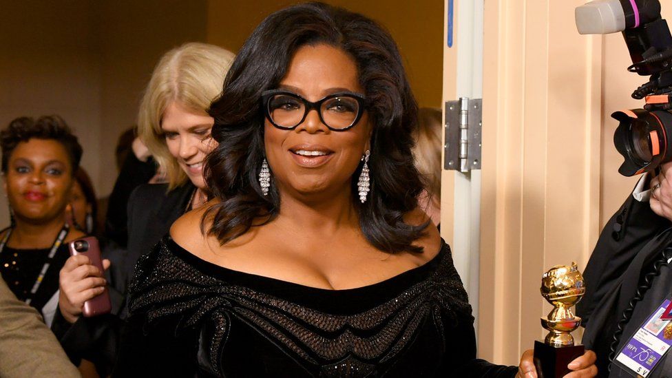 Oprah Winfrey smiles for the cameras after her Golden Globe speech.
