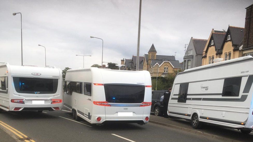 Stolen caravans block the A487 at the Morrison's roundabout in Caernarfon, Gwynedd