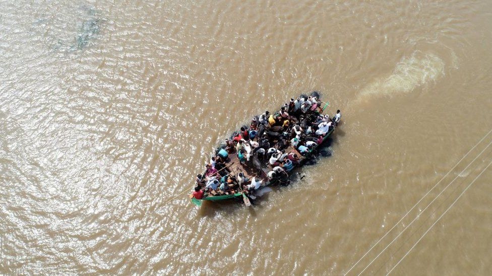 An aerial view of locals being rescued on a boat in waterlogged Jamkhandi Taluk at Belgaum district of Karnataka state situated about 525 kms north of the south Indian city of Bangalore on August 11, 2019.