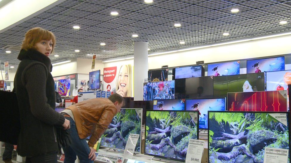 Russian shoppers in TV showroom in Moscow