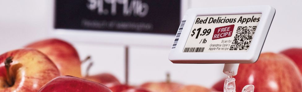 Electronic label next to red apples