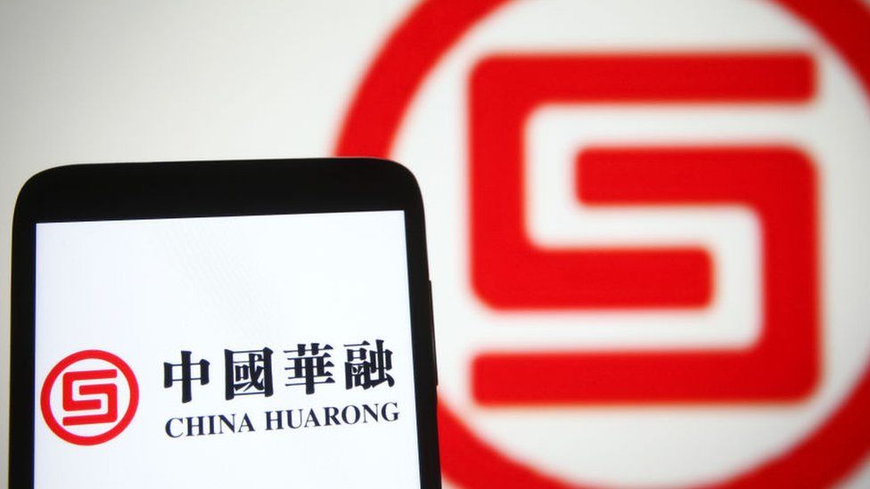 China Huarong Asset Management Co. logo is seen on a smartphone screen.