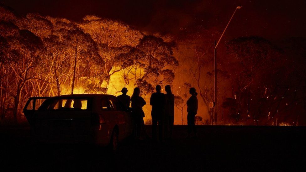 Residents look on at a fire in New South Wales