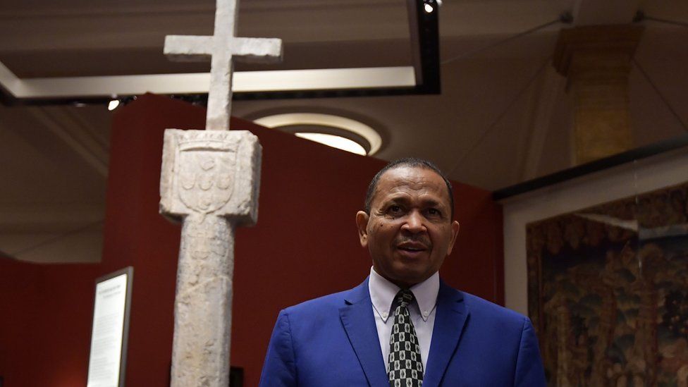 Namibia's Ambassador to Germany Andreas Guibeb posing with the Stone Cross