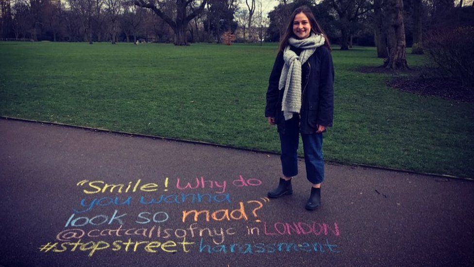 Sophie Sandberg standing next to a catcall written out on the ground