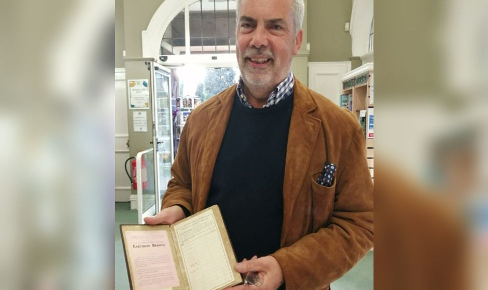 A man holding a library book