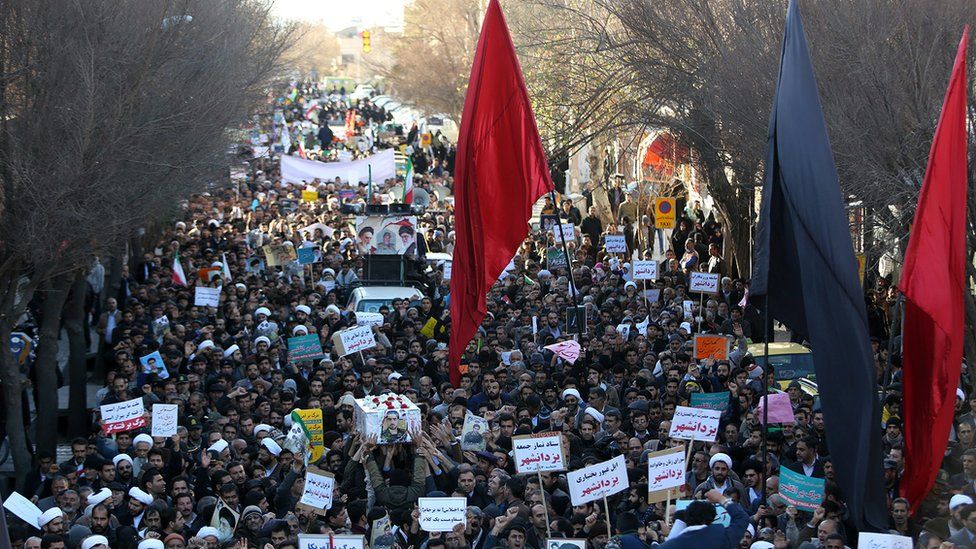 Iranian pro-government supporters march during the funeral of a young member of the Revolutionary Guards, Sajjad Shahsanai, in the city of Najafabad, west of Isfahan, on Wednesday