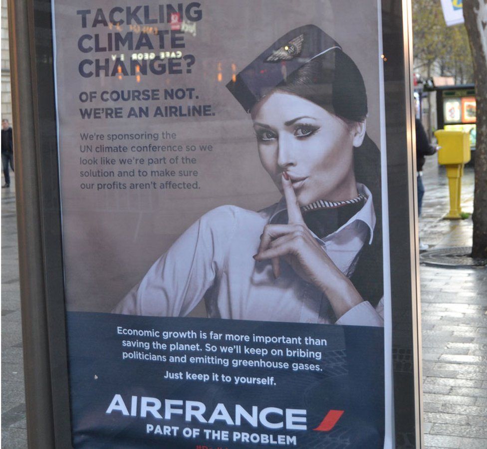 A poster parodying Air France reads: "Tackling climate change? Of course not, we're an airline"