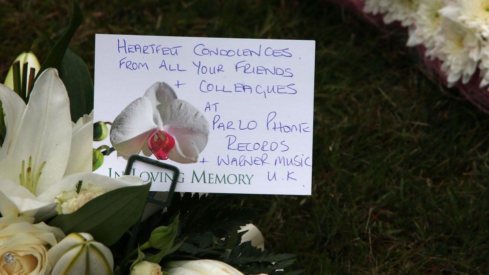 Floral tributes outside St Mary's Church included a message from her record company