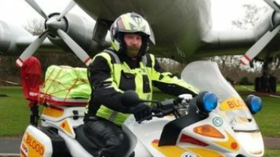 Blood Biker in front of aeroplane