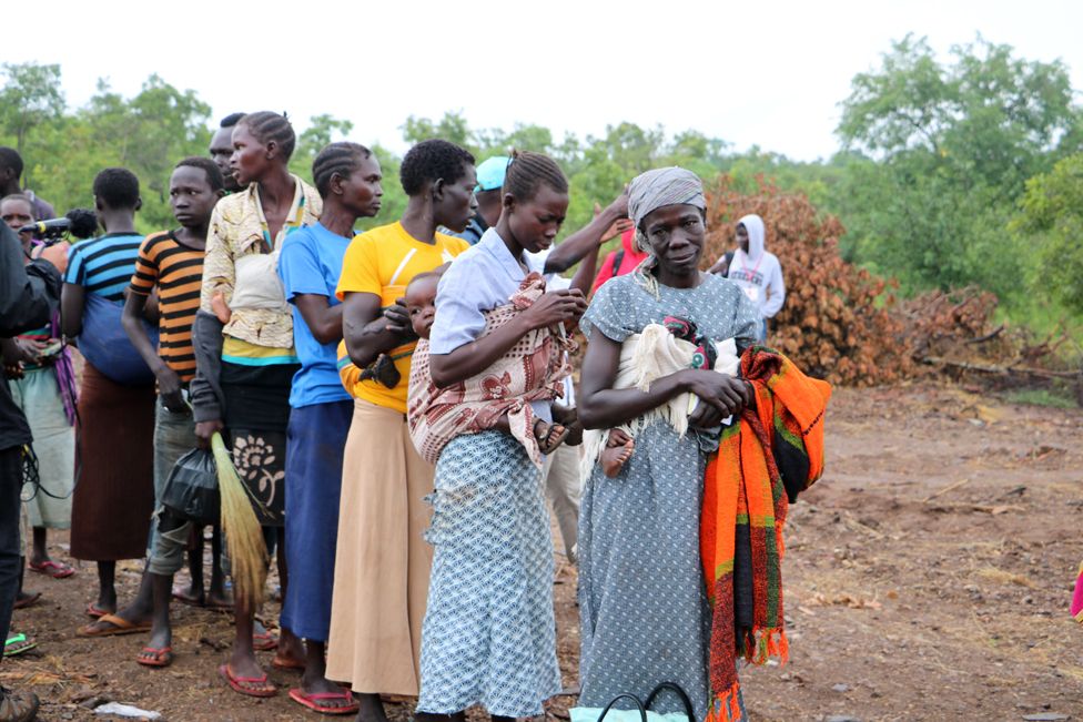 A line of women wait to be shown where they will be living