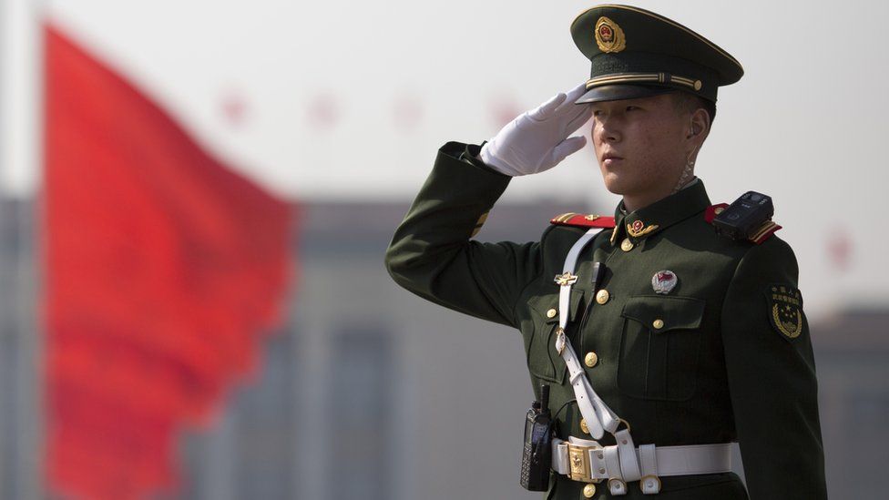 A Chinese paramilitary policeman salutes near the Great Hall of the People at the opening of the Chinese People's Political Consultative Conference (CPPCC) in Beijing, China, 3 March 2017