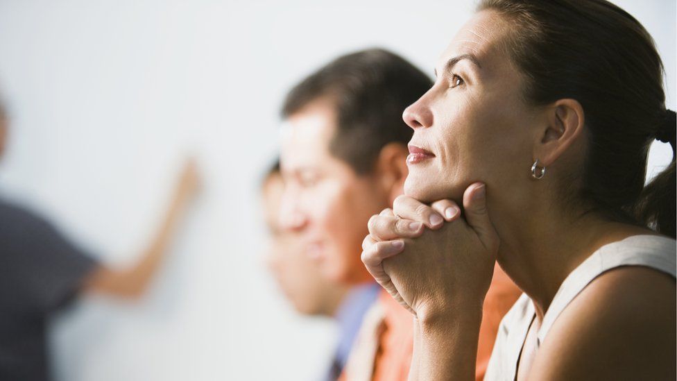 woman sitting next to man