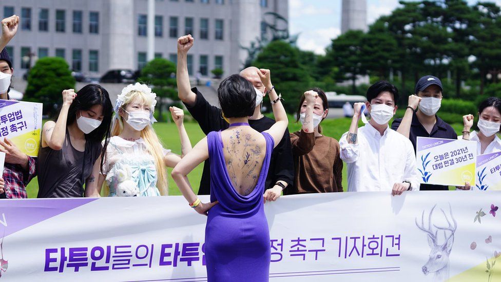 Lawmaker Ryu Ho-jeong promotes bill on tattooing in front of National Assembly complex in Seoul showing erasable tattoos on her back
