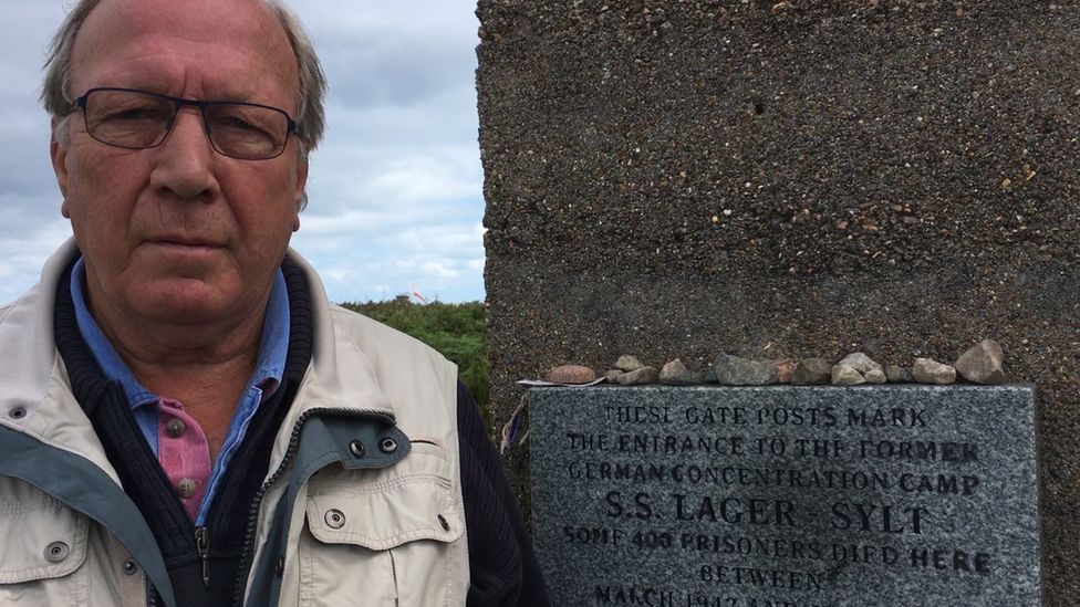 Alderney politician Graham McKinley next to the entrance of former concentration camp site Lager Sylt in Alderney