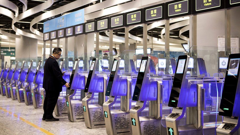 A man uses an immigration clearance machine at the Hong Kong Express Rail Link
