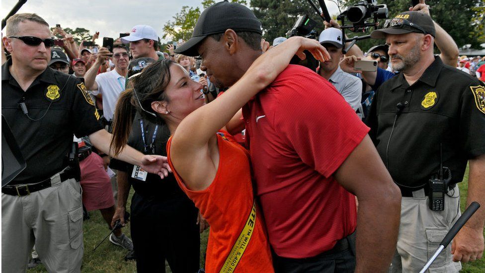 Tiger Woods and Erica Herman celebrate after a golf event in 2018